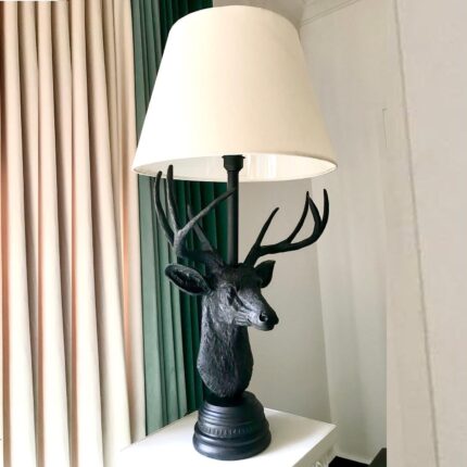 European Deer Table Lamp — rustic animal lamp with matte black sculpted stag base and cream linen shade