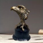Gold eagle sculpture bust with intricate feather detail on black base – animal sculpture art by Lume Art Gallery