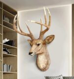 Handcrafted polyresin deer wall art sculpture with detailed antlers and realistic texture in beige finish, rustic animal lamp décor