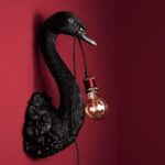Black Swan Wall Lamp — sculptural swan animal lamp in matte black finish with red socket detail, decorative modern wall art decor, hallway and entryway