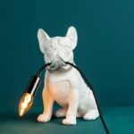 Francis White Dog Lamp — sculptural polyresin dog table lamp holding a light bulb, a premium animal lamp for modern living rooms and home décor