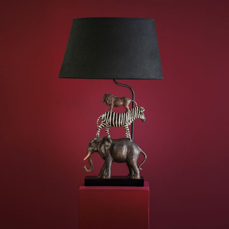 Table Lamp Lion Zebra Elephant Safari featuring stacked lion, zebra and elephant sculptures with dark bronze finish and black shade — animal lamp for modern living rooms Table Lamp Lion Zebra Elephant Safari featuring stacked lion, zebra and elephant sculptures with dark bronze finish and black shade — animal lamp for modern living rooms