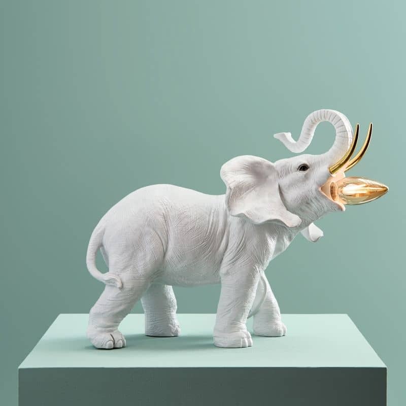 Dumbo Elephant Lamp – sculptural animal lamp in polyresin with white and gold tusks, ideal for modern living room decor Dumbo Elephant Lamp – sculptural animal lamp in polyresin with white and gold tusks, ideal for modern living room decor