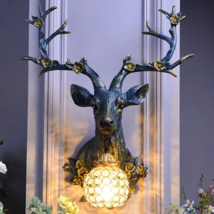 Black Deer antler lamp with blue and gold sculptural wall decor featuring crystal globe light and floral antler details – decorative wall lights by Lume Art Gallery