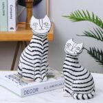Graceful Feline Sculpture, black and white resin cat sculpture — modern animal sculpture for home décor by Lume Art Gallery