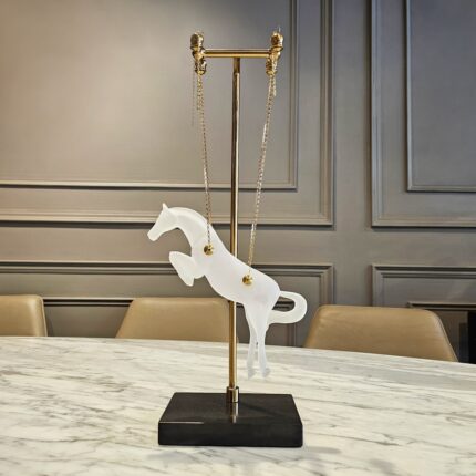 Hanging horse sculpture with frosted glass body, gold chains, and marble base - modern floor sculpture and luxury home decor piece