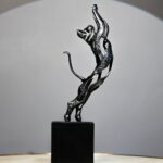 Black Feline Sculpture — glossy black cat sculpture of a leaping panther with abstract curves, a modern art sculpture and animal sculpture for sale at Lume Art Gallery