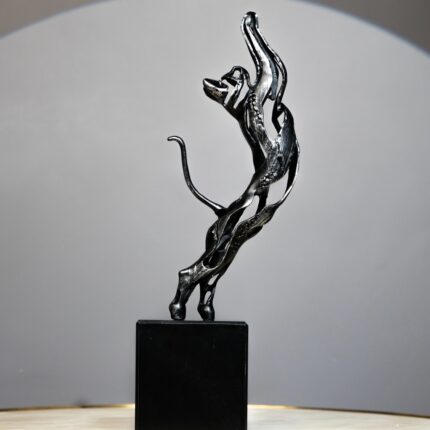 Black Feline Sculpture — glossy black cat sculpture of a leaping panther with abstract curves, a modern art sculpture and animal sculpture for sale at Lume Art Gallery