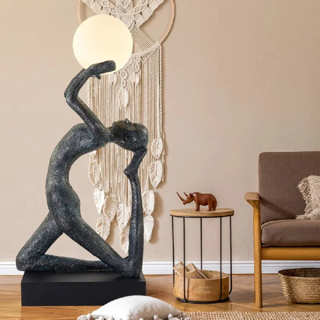 Black wooden tripod lamp with fabric drum shade in minimalist interior