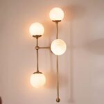 ARMSTRONG FOUR-LIGHT BRASS AND GLASS SCONCE WALL LIGHT