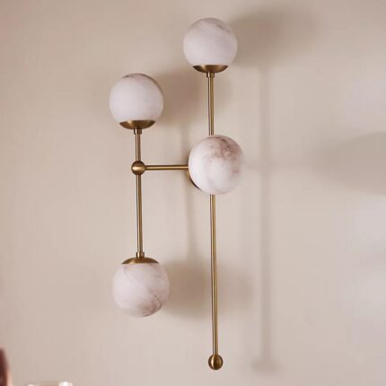 ARMSTRONG FOUR-LIGHT BRASS AND GLASS WALL SCONCE