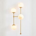 ARMSTRONG FOUR-LIGHT WALL SCONCE WITH BRASS AND GLASS