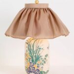 CARVED CERAMIC BERNADETTE TABLE LAMP WITH A SKIRTED SHADE