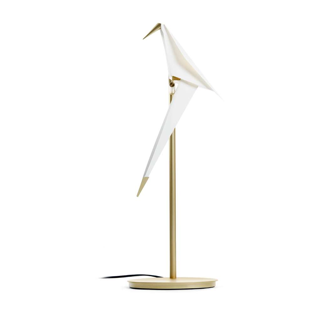 PERCH TABLE LIGHT BY UMUT YAMAC with single white origami paper bird perched on slim brass stem and round gold base, swivel design PERCH TABLE LIGHT BY UMUT YAMAC with single white origami paper bird perched on slim brass stem and round gold base, swivel design