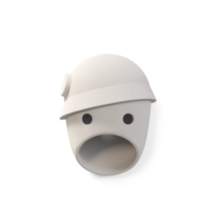 THE PARTY COCO WALL LAMP BY KRANEN GILLE — matte white cast ceramic face wall lamp with a rounded dome cap, circular eye openings, and oval mouth aperture