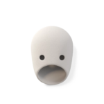 THE PARTY TED WALL LAMP BY KRANEN GILLE — white ceramic face wall lamp with oval form, two small symmetric circular eye openings, and a wide oval mouth aperture