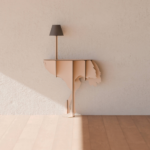 NUDE OSTRICH WALL LAMP by Rachel & Benoît Convers — warm nude flat cut ostrich body with slim pole and dark lamp shade, nearly tone-on-tone against cream plaster wall