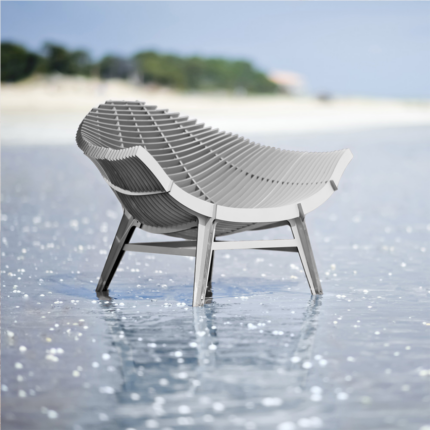 WHITE ARMCHAIR BY RACHEL & BENOIT CONVERS— wide seat photographed from the rear three-quarter angle standing in shallow coastal water