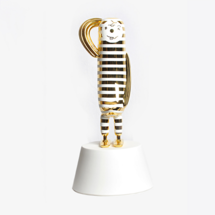 STRIPES HOPE BIRD BY JAIME HAYON — gold and white striped ceramic bird with character face and 24K gold details, on white ceramic pedestal.