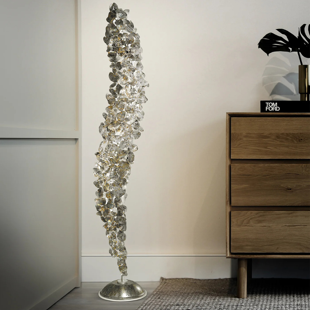 CORTEN METAL FLOOR LAMP WITH SILVER FINISH with overlapping spiral leaf panels glowing amber, 74.8 in tall, styled beside oak dresser CORTEN METAL FLOOR LAMP WITH SILVER FINISH with overlapping spiral leaf panels glowing amber, 74.8 in tall, styled beside oak dresser