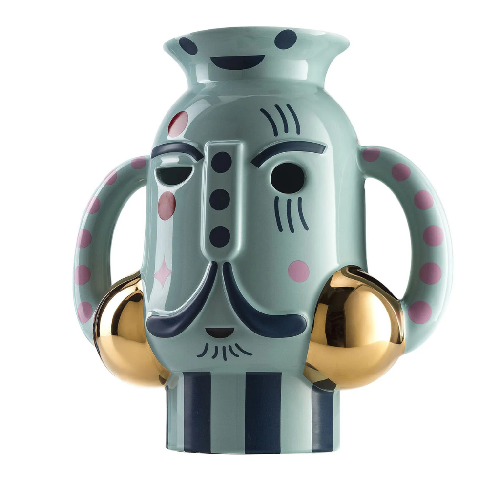 KING VASE GLOSSY GREEN CERAMIC WITH METAL DETAILS VASE with illustrated face, pink polka dot loop handles, gold sphere accents, and dark navy stripes KING VASE GLOSSY GREEN CERAMIC WITH METAL DETAILS VASE with illustrated face, pink polka dot loop handles, gold sphere accents, and dark navy stripes