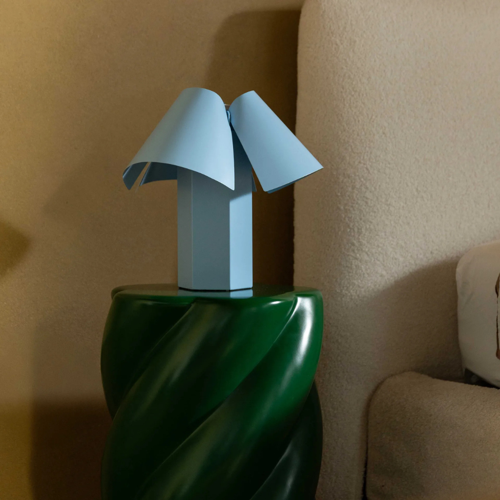 TABLE LAMP BELN POWDER BLUE with hexagonal rectangular block base and three overlapping softly rolled curved shade panels TABLE LAMP BELN POWDER BLUE with hexagonal rectangular block base and three overlapping softly rolled curved shade panels